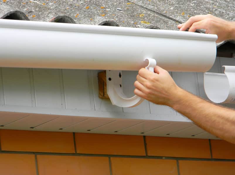 Picture of Contractor installing plastic roof gutter.