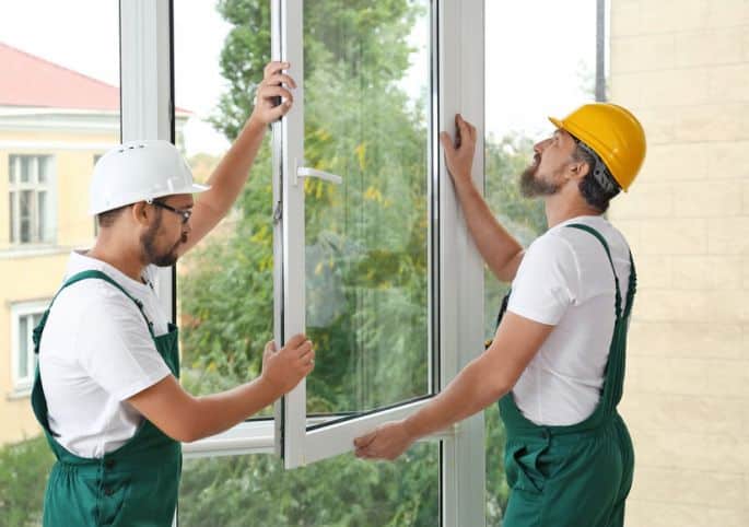 Picture of contractors replacing windows.
