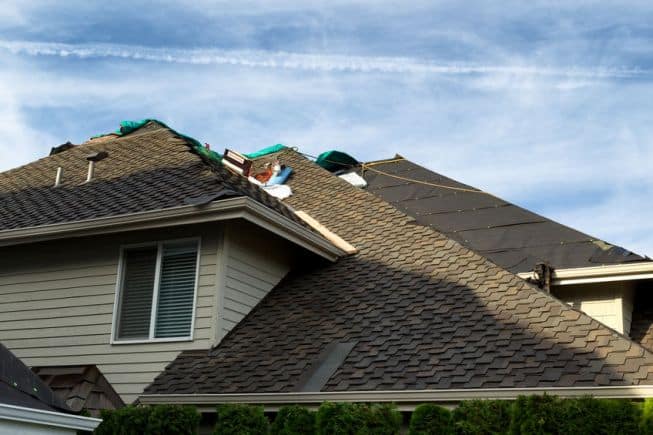 Picture of contractors winterizing a roof in Minnesota.